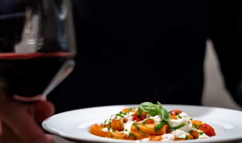 La Veranda & San Marco Restaurant Fresh rigatoni pasta with tomato sauce and fresh cheese served with a glass of red wine at ARIA Retreat & SPA by Kenwood Travel