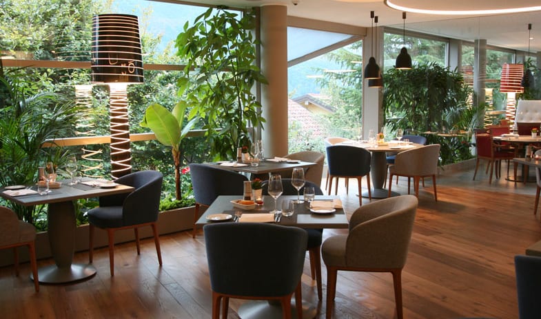 La Joie de Vivre Restaurant Modern dining room with large window views of greenery and mountain scenery at ARIA Retreat & SPA by Kenwood Travel