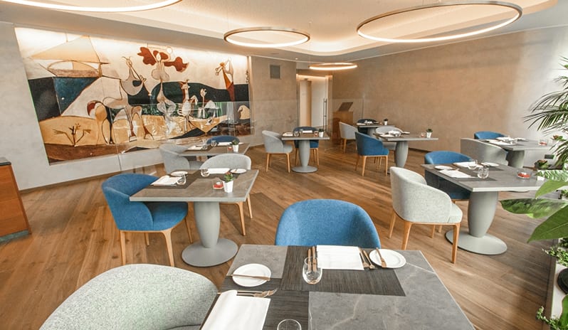 La Joie de Vivre Restaurant Spacious hotel restaurant dining room with elegant modern seating, wooden floors, and modern lighting at ARIA Retreat & SPA by Kenwood Travel