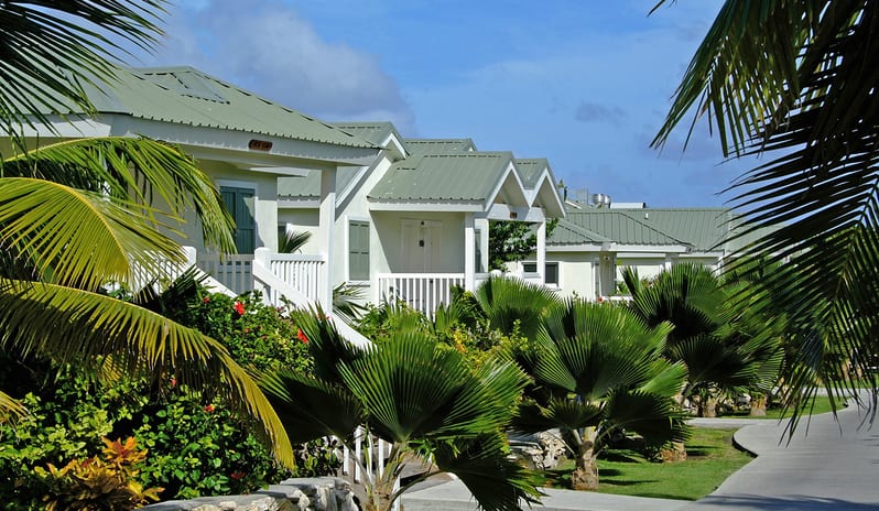 Hillside Suite Garden/Resort Views villas surrounded by palm trees alongside a paved walking path at The Verandah Antigua by Kenwood Travel
