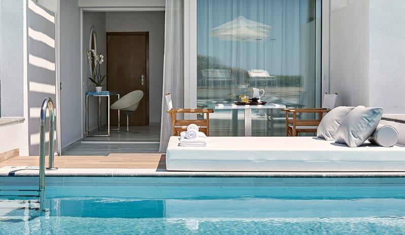 Swim-up Guestroom Sea View Private swim-up pool suite with daybed and covered patio terrace at Grecotel LUXME White by Kenwood Travel