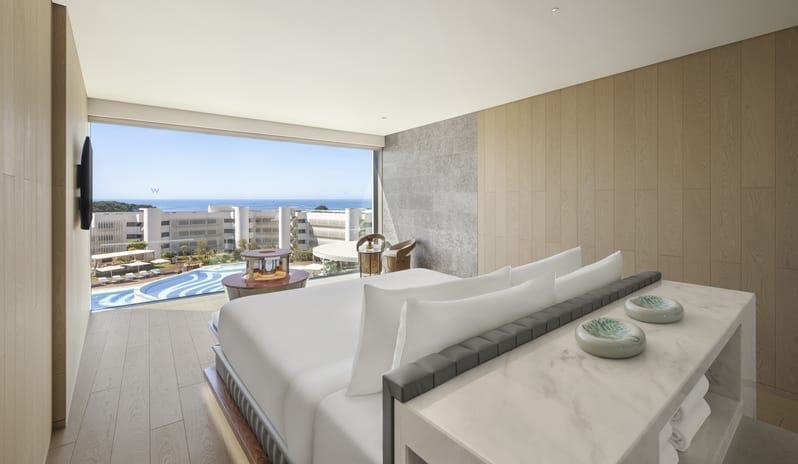 Penthouse II Suite, One Bedroom Suite with Pool Luxury penthouse suite bedroom with wood panelling and a panoramic ocean view at  W Algarve by Kenwood Travel