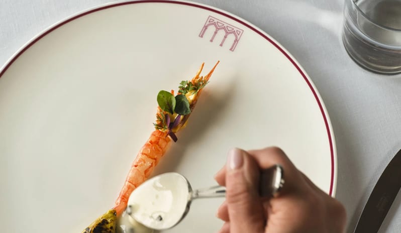 Altariva Restaurant Chef plating a gourmet seafood course on custom chinaware at Palazzo Venezia by Kenwood Travel