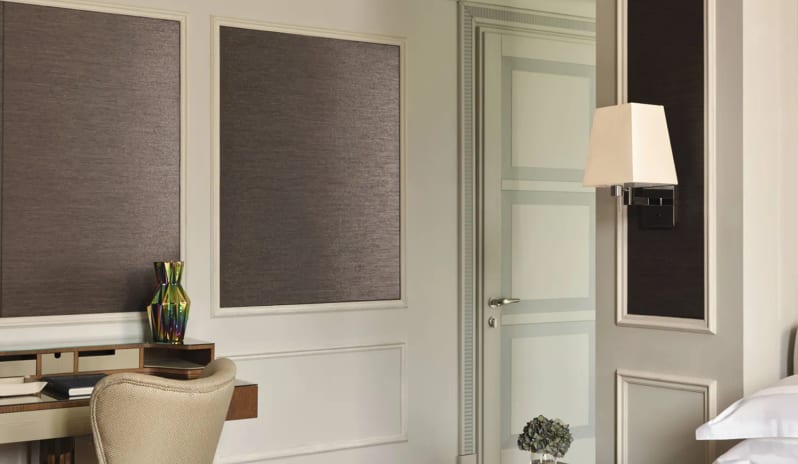 Premium Room Cozy bedroom layout in a luxury hotel suite with a vanity writing desk, decorative glass vase, nightstand, and bed corner at Palazzo Venezia by Kenwood Travel