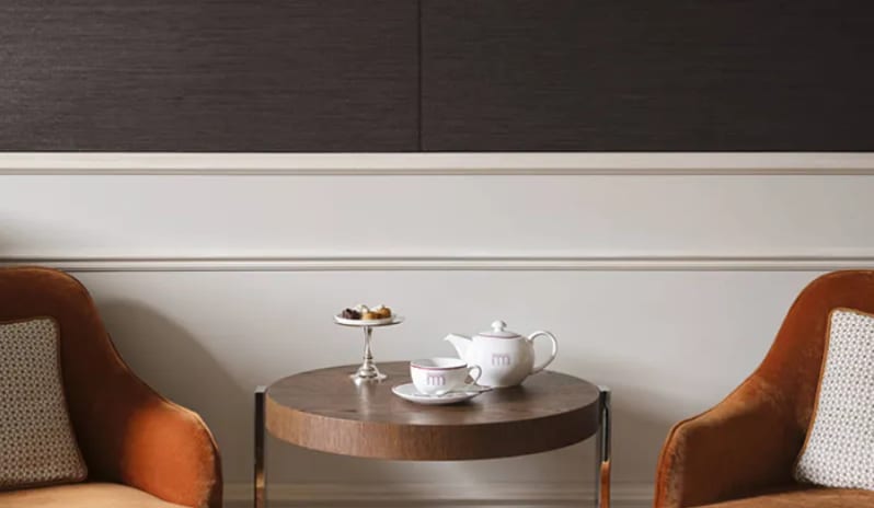 Premium Room Tea service on a side table between two orange armchairs in a Premium Room at Palazzo Venezia by Kenwood Travel