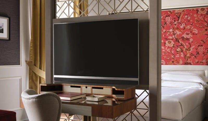 Junior Suite Writing desk and TV partition separating the living space and bed at Palazzo Venezia by Kenwood Travel