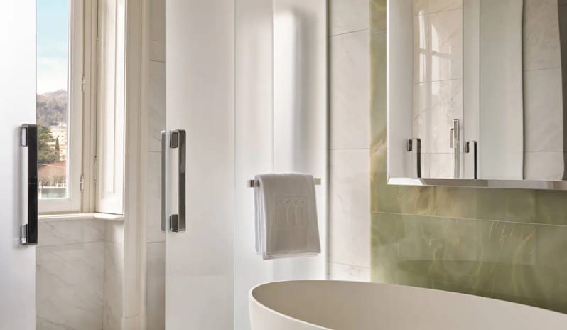 Premium Room Freestanding soaking bathtub and green onyx wall in a Premium Room bathroom at Palazzo Venezia by Kenwood Travel