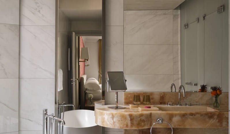 Junior Suite Honey-amber onyx stone vanity and tub detail in a Junior Suite bathroom at Palazzo Venezia by Kenwood Travel