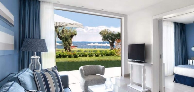 One Bedroom Bungalow Suite Garden Seaside resort suite with a living room, bedroom, and ocean view Ikos Olivia by Kenwood Travel