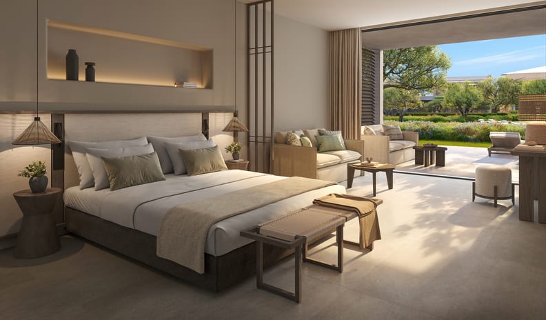 Junior Suite Room Private Garden Pool View Warm modern hotel bedroom opening onto a private garden patio at Ikos Kissamos by Kenwood Travel