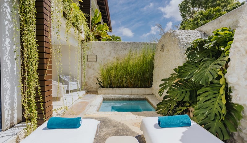 Luxury Pool Suite Secluded resort villa pool deck equipped with plush sunbeds and teal towels beside a courtyard plunge pool at Blue Monkey Hotel & Beach Club by Kenwood Travel