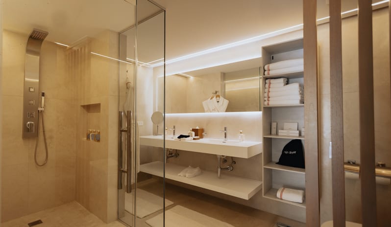 Executive Room (Second bedroom of the Luxury Two Bedroom Suite) Spacious luxury bathroom with a walk-in shower and backlit vanity at Blue Monkey Hotel & Beach Club by Kenwood Travel