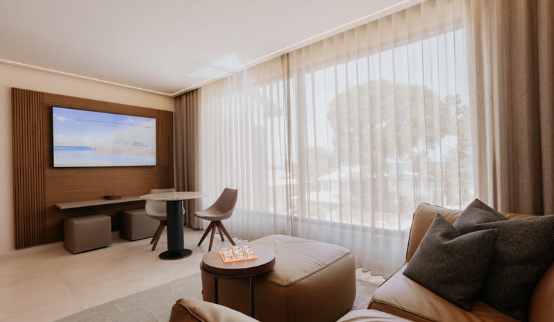 Blue Monkey Signature One Bedroom Suite Spacious living room lounge inside a luxury resort suite at Blue Monkey Hotel & Beach Club by Kenwood Travel
