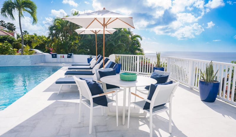 Presidential Manor Luxury beach resort outdoor terrace with private swimming pool, sunbathing loungers, patio dining set, and panoramic sea views at Windjammers Landing by Kenwood travel