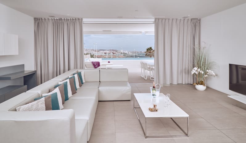 Divine Breeze Spacious luxury penthouse living area overlooking a private patio and infinity pool at Domes Baobab by Kenwood Travel