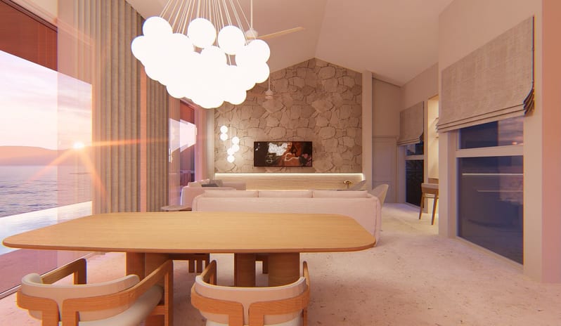 Hillside Penthouse Bright interior view of a luxury hillside penthouse living and dining area featuring wooden furniture, a stone accent wall, a large cloud-like pendant light, and large windows overlooking the sea at The Calabash Hotel by Kenwood Travel