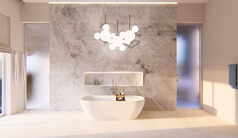 Hillside Penthouse Modern luxury bathroom interior featuring a freestanding white bathtub set against a textured marble accent wall, illuminated by a bubble chandelier and warm recessed lighting at The Calabash Hotel by Kenwood Travel