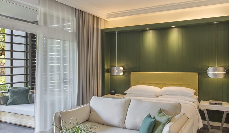 Junior Suite Premium sofa lounge, ceiling fan, and sliding doors opening to a private balcony daybed at Long Beach Mauritius by Kenwood Travel