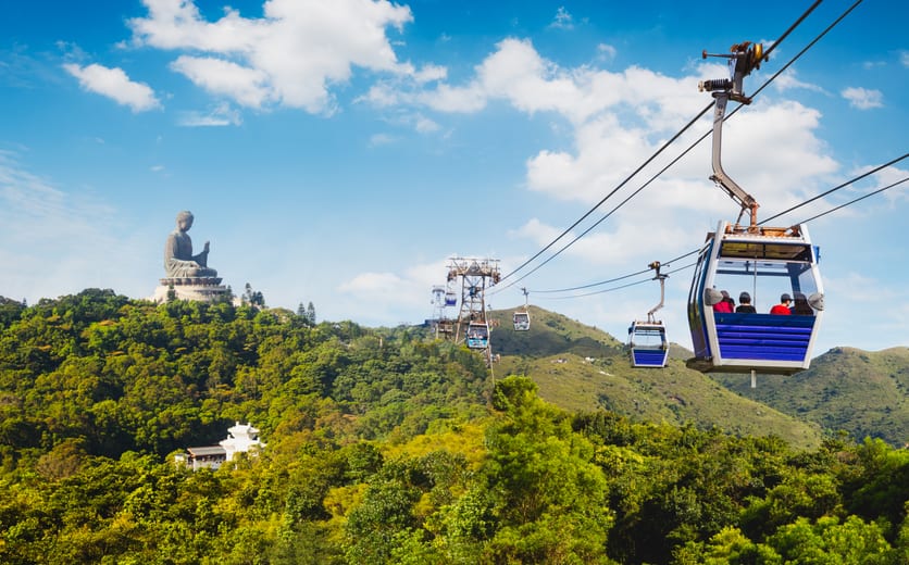 Ngong Ping cable car with big buddha statue in background, Hong Kong China.jpg