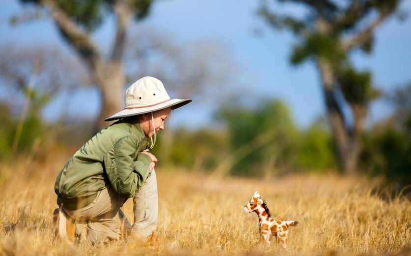 Adorable little girl in South Africa safari with giraffe to.jpg