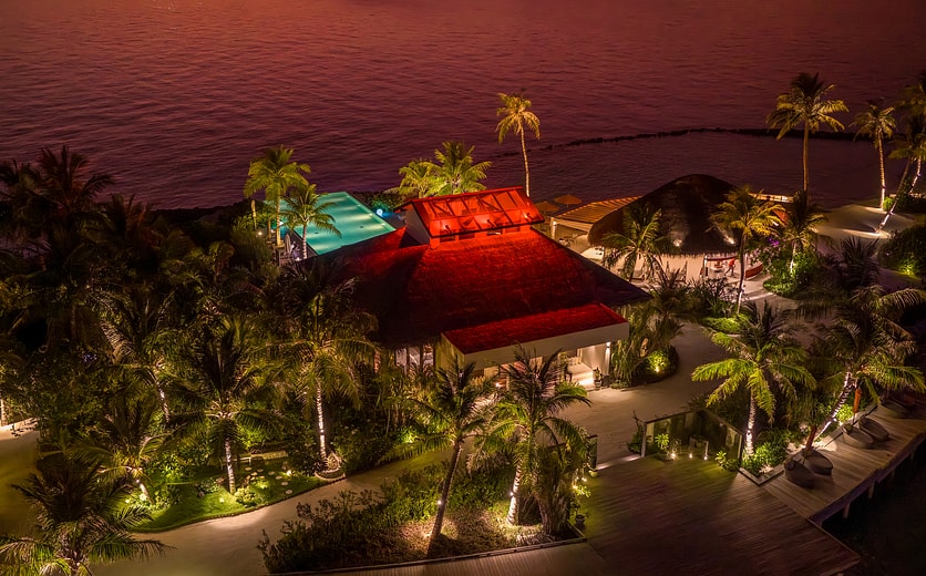 OBLU SELECT Lobigili - Full Island Aerial - Sunset - Swing Bar.jpg